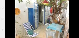 a room with a table and chairs and a tree at The 18, Marsa Guest House in La Marsa
