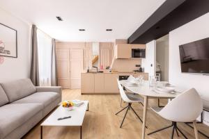 a living room with a couch and a table and chairs at Au Chat Qui Dort Lille - Archives 3 in Lille +13 photos