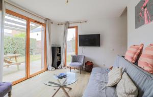 a living room with a couch and a glass table at Jolie Maison Avec Terrasse in Le Crotoy