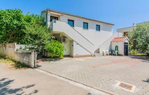 a house with a staircase in front of it at Cozy Apartment In Nin With Wifi in Nin