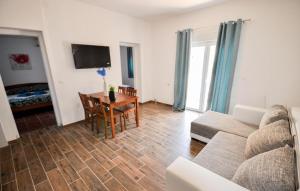 a living room with a couch and a table at Lovely Apartment In Novigrad in Karpinjan +9 photos