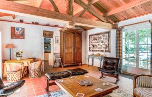 a living room with a couch and a table at Amazing Home In La Boissières Des Land in Saint-Avaugourd-des-Landes