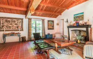 a living room with a table and a fireplace at Amazing Home In La Boissières Des Land in Saint-Avaugourd-des-Landes