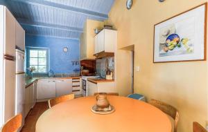a kitchen with a table and chairs in a room at Amazing Home In La Boissières Des Land in Saint-Avaugourd-des-Landes