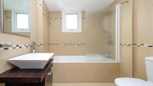 a bathroom with a tub and a sink and a shower at Villa Leoforos Dyo, Modern 3Bdr Protaras Villa With Pool, In The Centre Of Protaras in Protaras +23 photos