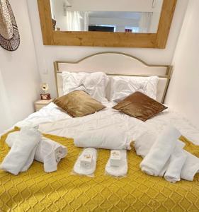 a bed with white sheets and two pairs of underwear and socks at Sympathy Studio For 2 Near The Sacre Coeur in Paris +17 photos