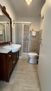 a bathroom with a sink and a toilet and a mirror at Casamare in Roseto degli Abruzzi +15 photos
