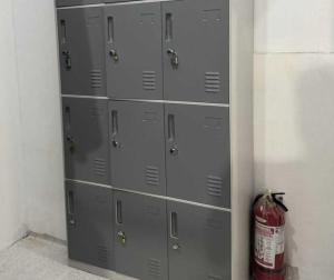 a bunch of lockers in a room with a fire extinguisher at OYO 1155 Carnivale Inn in Manila