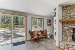 a living room with a table and chairs and a fireplace at The Rikz Cabin in South Lake Tahoe +18 photos