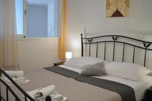 a bedroom with a bed with white pillows and a window at Villa Dabac in Sveti Juraj