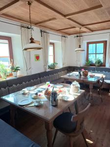 a dining room with tables and chairs with food on them at Stefflhof Mittersill in Mittersill