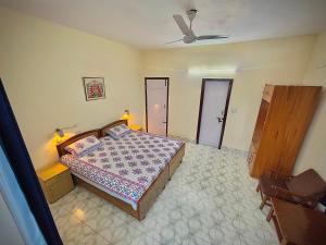 BhowāliにあるSoul Homestayのベッドと天井扇風機のある寝室 +3枚の写真