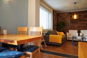 a living room with a table and chairs and a couch at Pension Sonnenheim inkl ZomerKärntenCard in Gmünd in Kärnten
