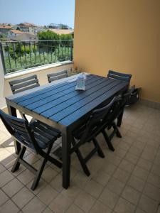 a wooden table and chairs on a balcony at Casa Cleo in Tortoreto Lido