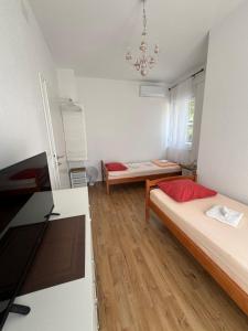 a small room with two beds and a table at Villa Sunshine in Orebić +39 photos