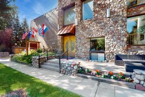 a stone building with flags in front of it at Aspen Mountain Lodge in Aspen