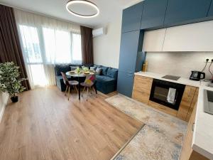 a kitchen and living room with a table and a couch at 2BR central escape in Varna City