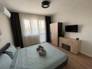 a bedroom with a bed with two teddy bears on it at 2BR central escape in Varna City