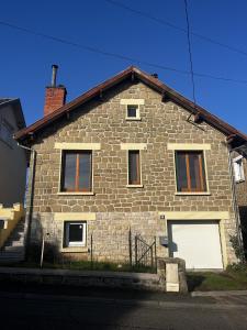 a brick house with two white doors on it at La Villa Pagnon - 3 Chambres in Brive-la-Gaillarde
