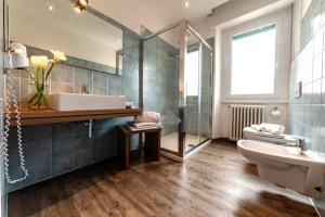 a bathroom with a sink and a toilet and a mirror at Hotel National in Zelbio +114 photos
