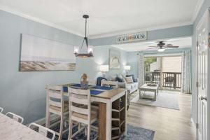 a dining room and living room with a table and chairs at Forest Beach Villa - 2 BDR for 6 in Hilton Head Island +23 photos