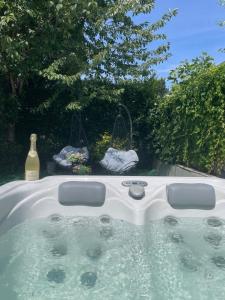 a hot tub with a bottle of wine in a yard at City Oase, House floor, fitness, garden, jacuzzi, close to subway U1 in Vienna