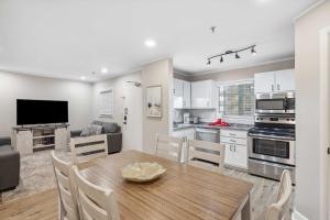 a kitchen and living room with a wooden table and chairs at Ocean Breeze - Island Retreat for 6 in Hilton Head Island