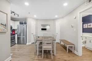 a kitchen with a table and chairs and a refrigerator at Ocean Breeze - Island Retreat for 6 in Hilton Head Island +18 photos