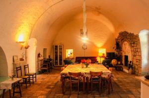 a dining room with a table in a large room at Masseria PietraViva in Altamura +38 photos