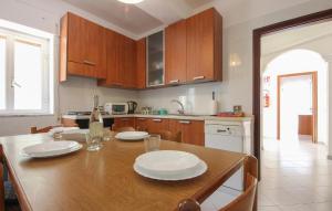 a kitchen with a wooden table with plates on it at Lovely Apartment In Agropoli With Wifi in Agropoli