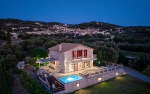 an aerial view of a house with a swimming pool at Arca Villa - Enchanting Sunset! in Keri