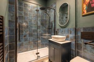 a bathroom with a sink and a shower at Vibrant 2-Bedroom Chapel Retreat in Barnard Castle
