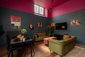 a living room with a couch and a table at Vibrant 2-Bedroom Chapel Retreat in Barnard Castle