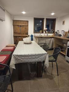 a table and chairs in a kitchen with a table and a table at Balkan Mountains Villa Spa in Elena