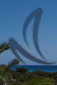 a wave in the sky over the ocean at Hotel Rosamar - Emar Hotels in Es Pujols