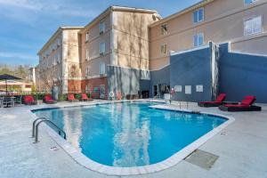 a large swimming pool in front of a building at Comfort Suites Nashville Airport - BNA in Nashville