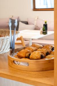a tray of pastries sitting on top of a table at Hotel Rosamar - Emar Hotels in Es Pujols