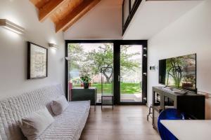 a living room with a bed and a sliding glass door at Green Molina in Faggeto Lario 