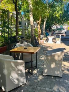 a wooden table and chairs in a park at STELA in Nesebar