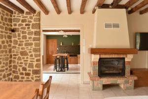 a living room with a fireplace and a dining room at Gîte La Mancellière - Maison familiale 12pers, grand jardin, jeux & pétanque - Pleine nature 