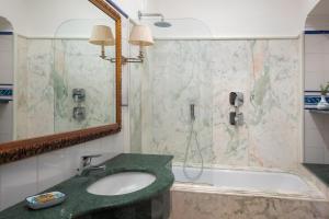 a bathroom with a sink and a shower at Hotel Caesar Augustus in Anacapri