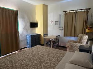 a bedroom with a bed and a table and a chair at Agriturismo Argentea in Arenzano