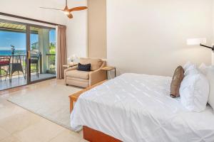 une chambre avec un lit et une chaise et un balcon dans l'établissement Hanalei Bay Resort 7308, à Princeville