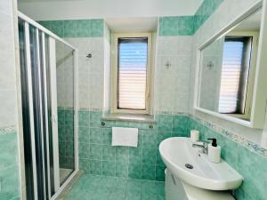 a bathroom with a sink and a shower at Palmira in Isola delle Femmine +22 photos