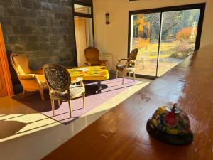 a living room with a table and chairs and a dining room at Arcano Casa Montaña in Villa La Angostura +18 photos