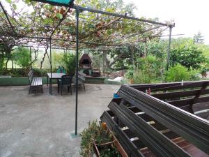 a patio with a table and a grill in a garden at Apartments in Novigrad - Istrien 31220 in Karpinjan