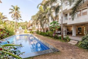 un'immagine di una piscina di fronte a un edificio di Pednekar's House, 1BHK with pool by SneekoStays a Nerul