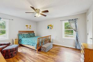 Un dormitorio con una cama y un ventilador de techo. en Crestview 261, en Sugar Mountain