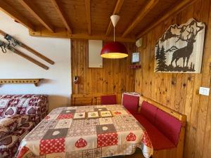 a room with a table and a bed and a lamp at Les Saisies Appartement 3 Pièces 8 Pers. avec 2 SDB et Garage - FR-1-293-275 in Hauteluce