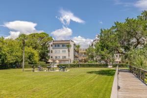 a park with a wooden walkway in front of a building at Shipwatch #305 in Saint Simons Island